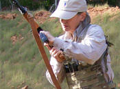 Janet Katz loads an AK-47 from her BCS Low Profile chest rig that works well for women.